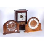 A mid 20th century Smiths oak cased mantel clock, h.18cm; together with two other examples (3)
