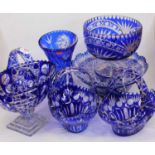 A collection of Bohemian style blue overlaid and etched glassware, to include a trumpet shaped vase,