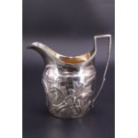 A George III silver cream jug, of helmet form with reeded rim and conforming shouldered handle,