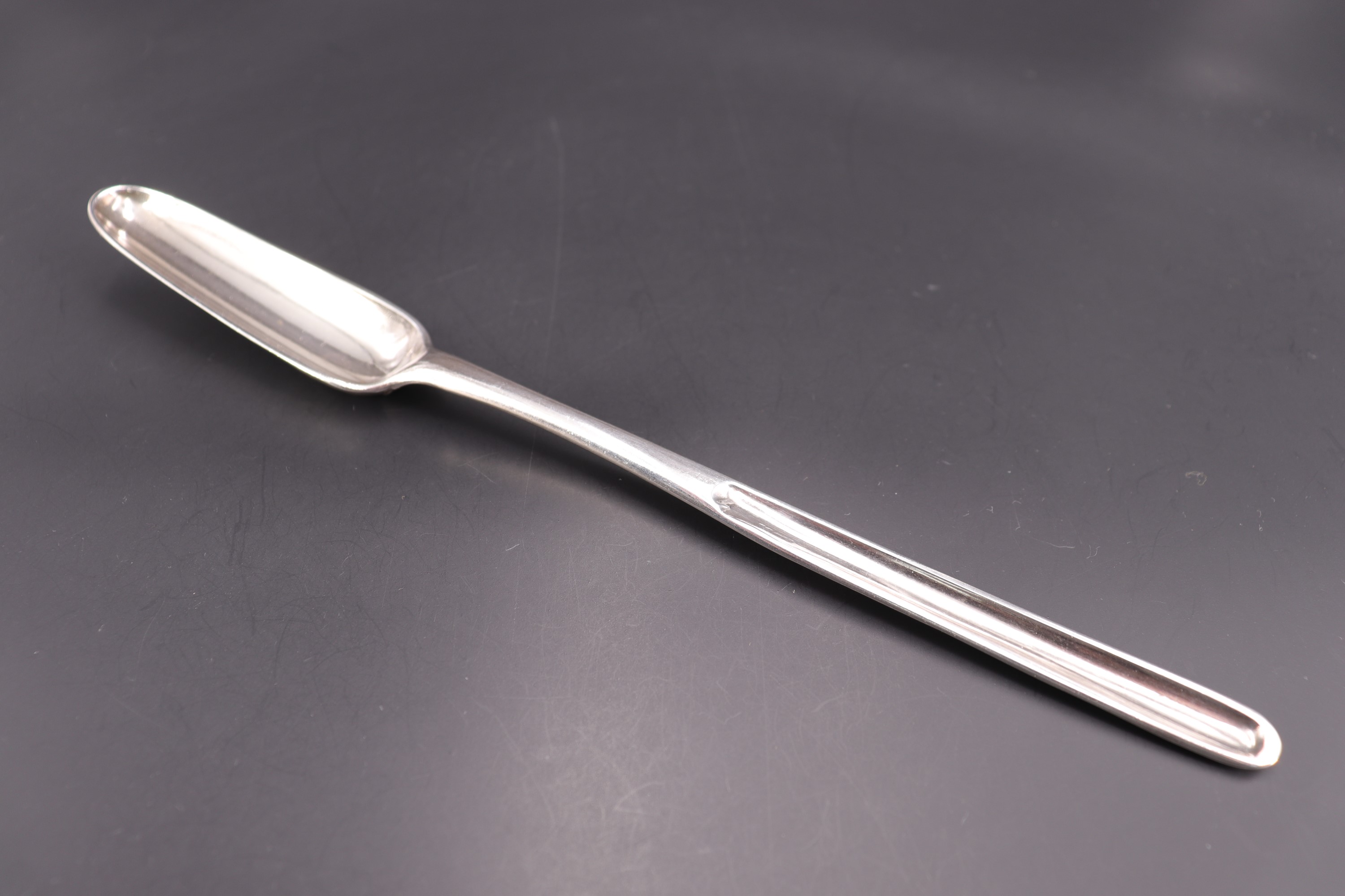 An 18th Century silver scroll-back marrow spoon, bearing engraved marriage marks, WW, London, likely
