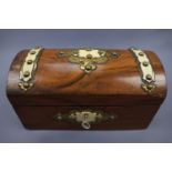 A Victorian walnut two compartment tea caddy decorated with gilt brass strapwork