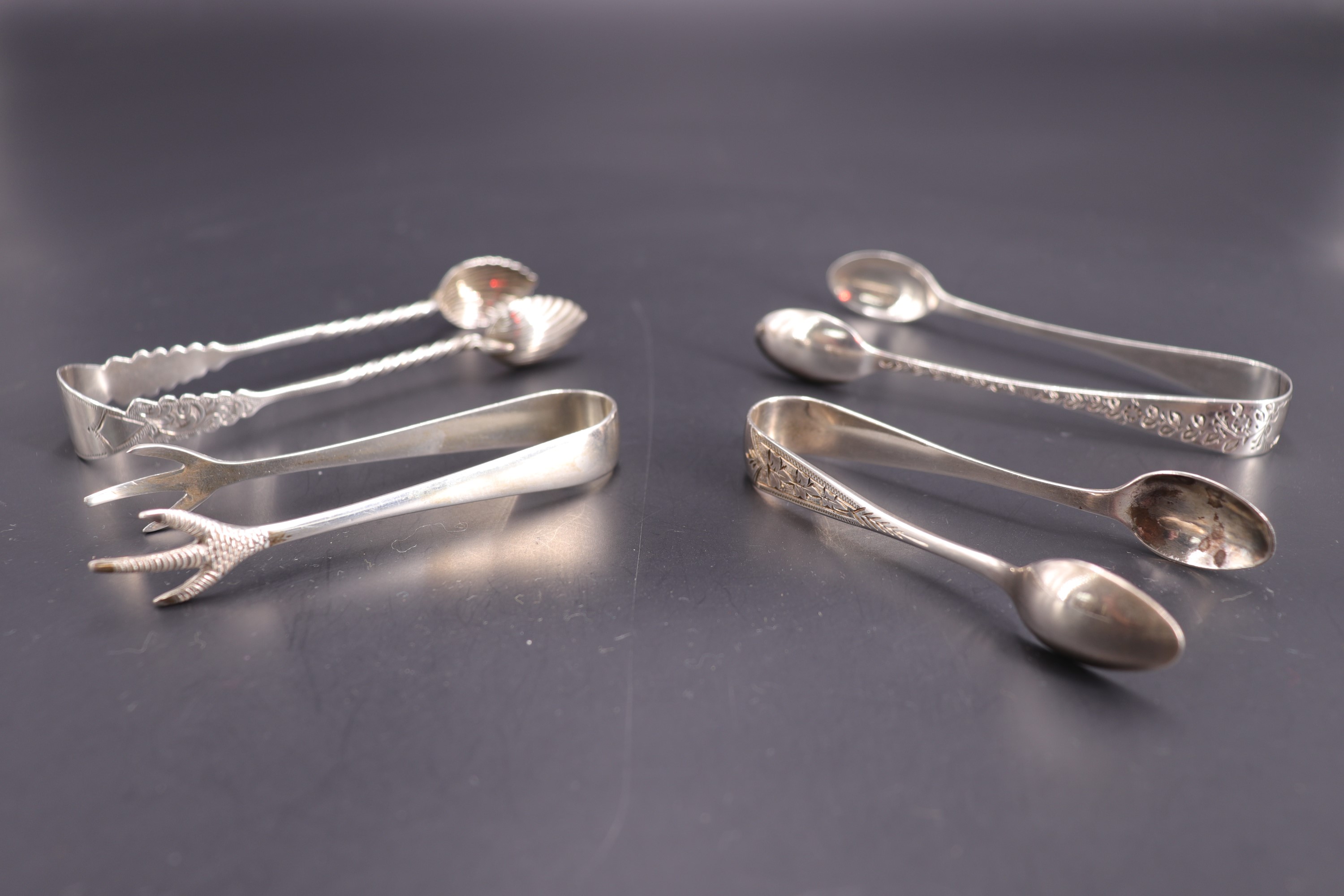 Four sets of silver sugar tongs, 45 g, longest 9 cm