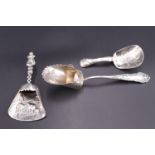 An early 20th Century Dutch silver caddy spoon, London import marks, 1919, together with two other