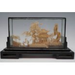A late 20th Century Chinese cork sculpture of a pagoda and garden with pond, in ebonized display