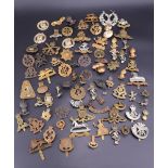 A large quantity of British cap badges etc