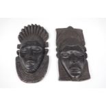 A pair of African carved ebony mask plaques, 21 cm