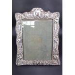 An Edwardian silver-faced photograph frame, relief-decorated in an Art Nouveau influenced
