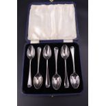 A cased set of six Edwardian Hanoverian scroll-back coffee spoons, Holland, Aldwinckle & Slater,