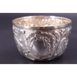 A late Victorian silver bowl, repousse-worked and engraved in a Rococo pattern centred by a vacant