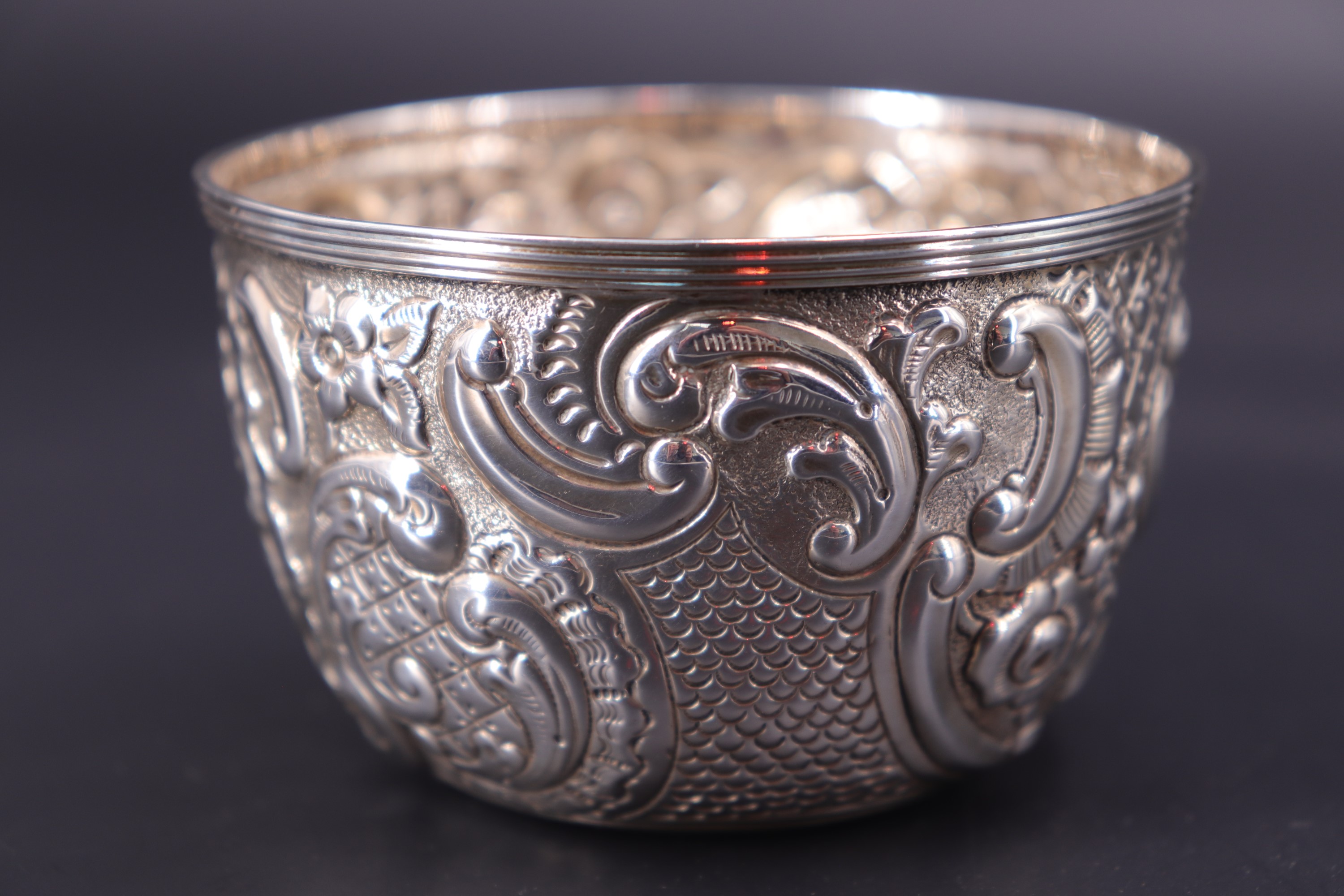 A late Victorian silver bowl, repousse-worked and engraved in a Rococo pattern centred by a vacant - Image 2 of 2