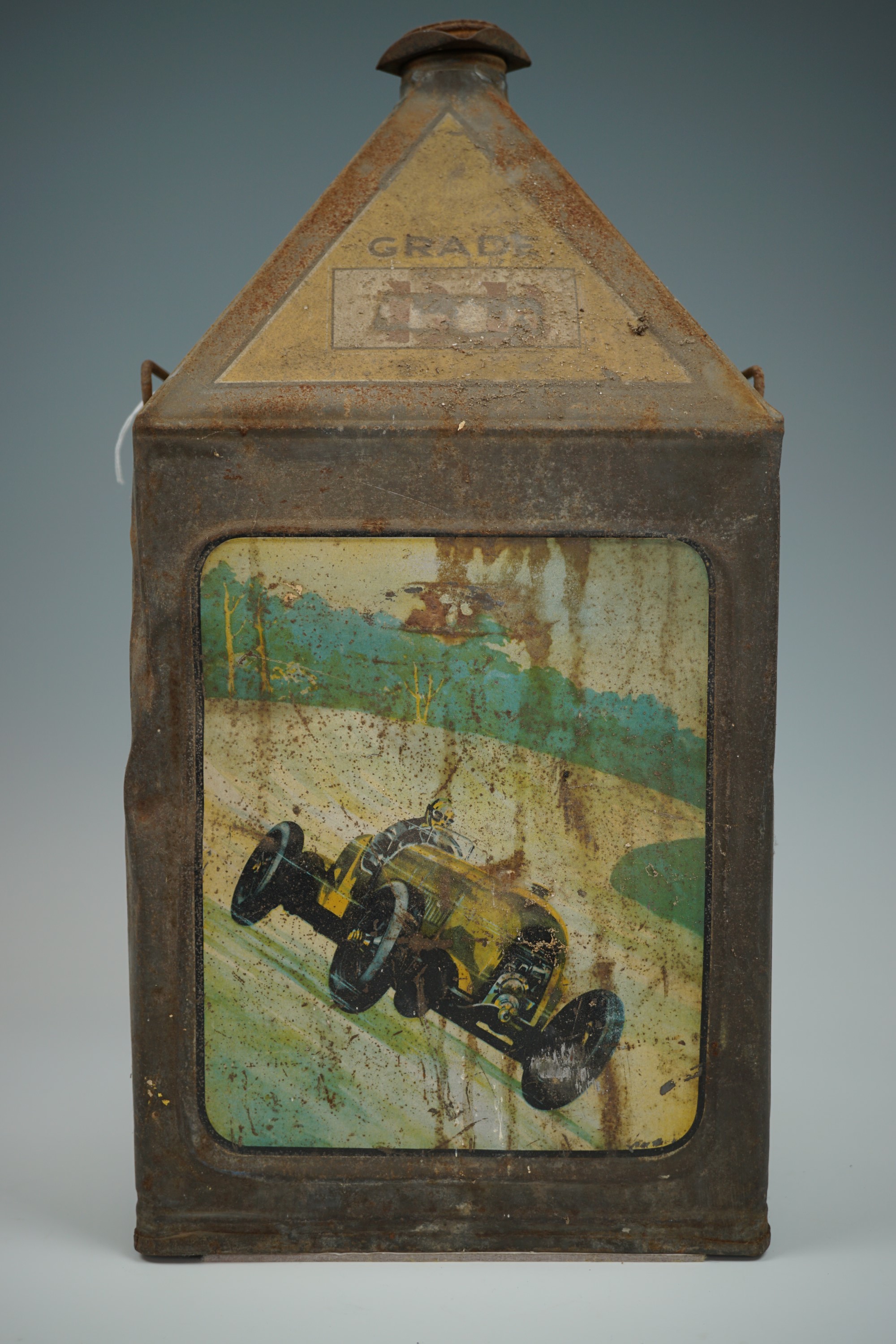 A 1930s Gamages 5-gallon fuel oil can, of so-called "pyramid" form, lithographically printed in