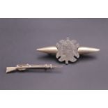 A sweetheart brooch fabricated from a French coin and bullets, together with a rifle-form brooch, (