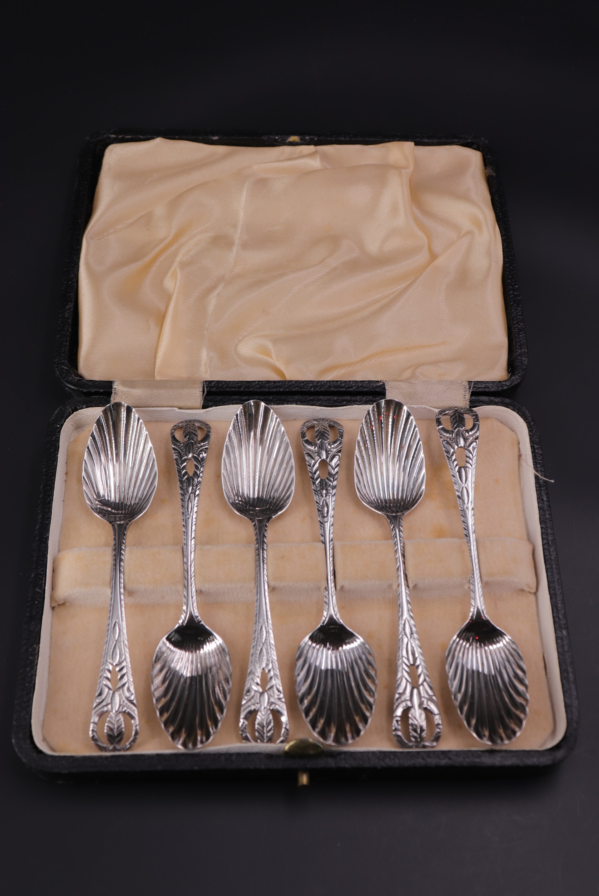 A set of six George III silver tea spoons, each having scalloped bowl, feather stem and pierced