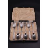 A set of six George III silver tea spoons, each having scalloped bowl, feather stem and pierced