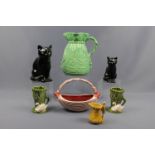A group of Sylvac ceramics including a black cat, a bag-form flower jug and a reeded basket, tallest