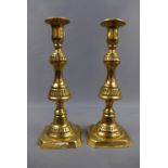 A pair of Victorian brass push-eject candlesticks, 25 cm