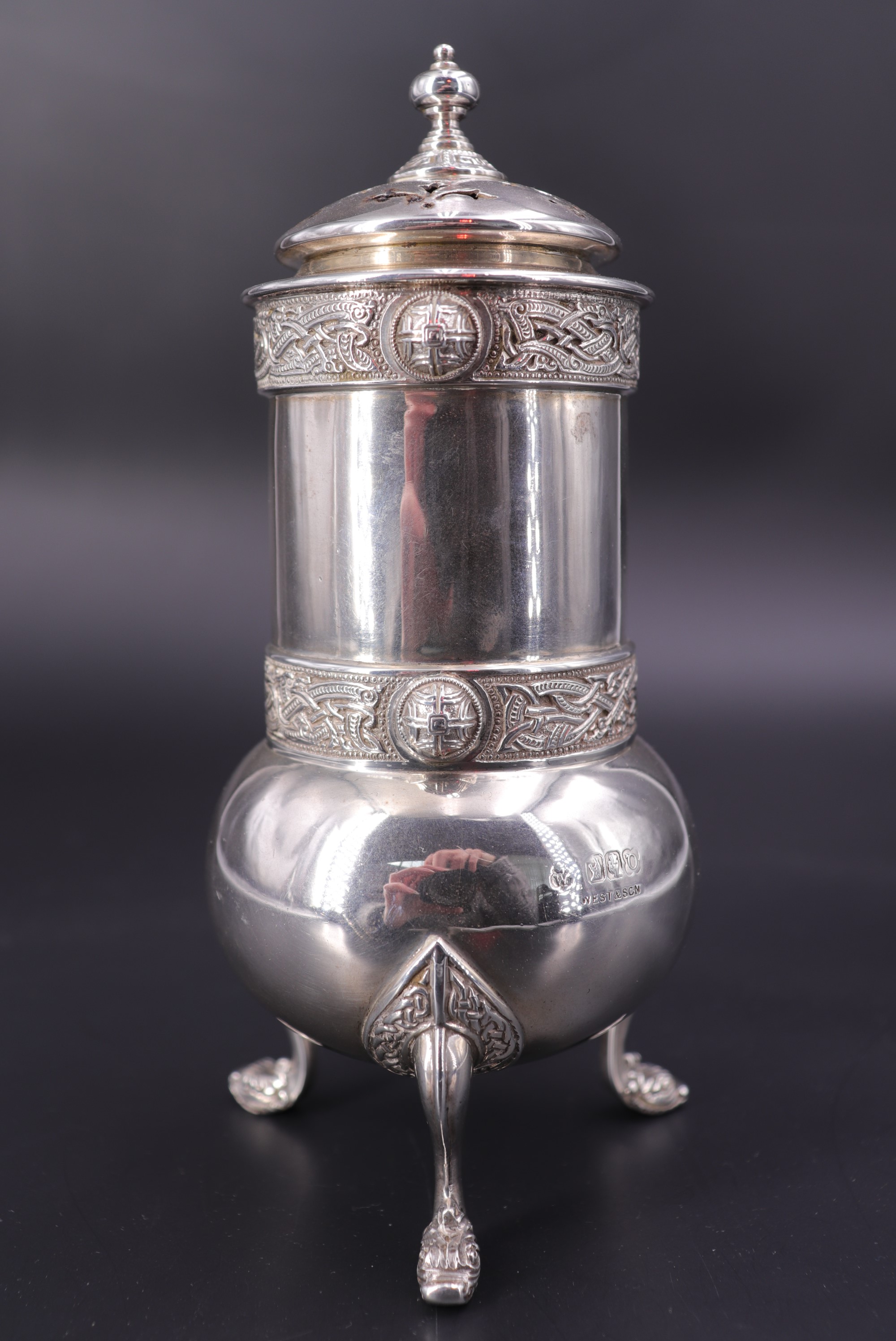 A George Irish silver sugar caster, of cylindrical form with oblate base supported on sort