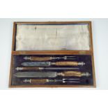 A Victorian silver-mounted and antler handled carving set by Mappin & Webb, in brass-mounted oak