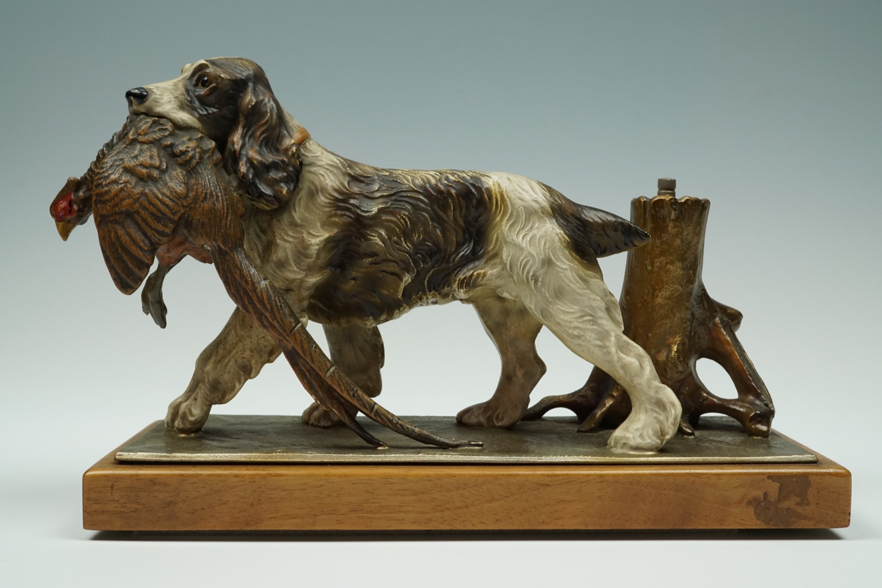 An Austrian cold-painted table lighter modelled as hound retrieving a pheasant, circa 1930s, 25 cm x