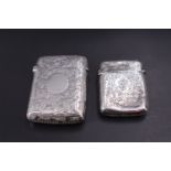 Two silver Vesta cases, late Victorian and Edwardian respectively, each profusely foliate engraved