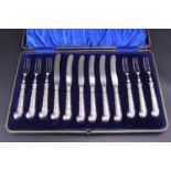 A cased set of Edwardian silver-handled fruit knives and forks, each having a "pistol" handle with