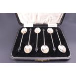 A cased set of silver coffee spoons with bean terminals, Roberts & Dore, Birmingham, 1922