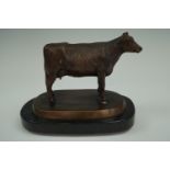 A metallic bronze-patinated cow, 14 cm high