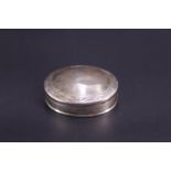 An engraved silver oval-section pill box