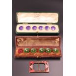 A cased set of Edwardian amethyst-enamelled silver waistcoat buttons together with a cased part