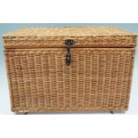 A woven box containing a large quantity of new-old-stock and as-new vintage babies' clothing,