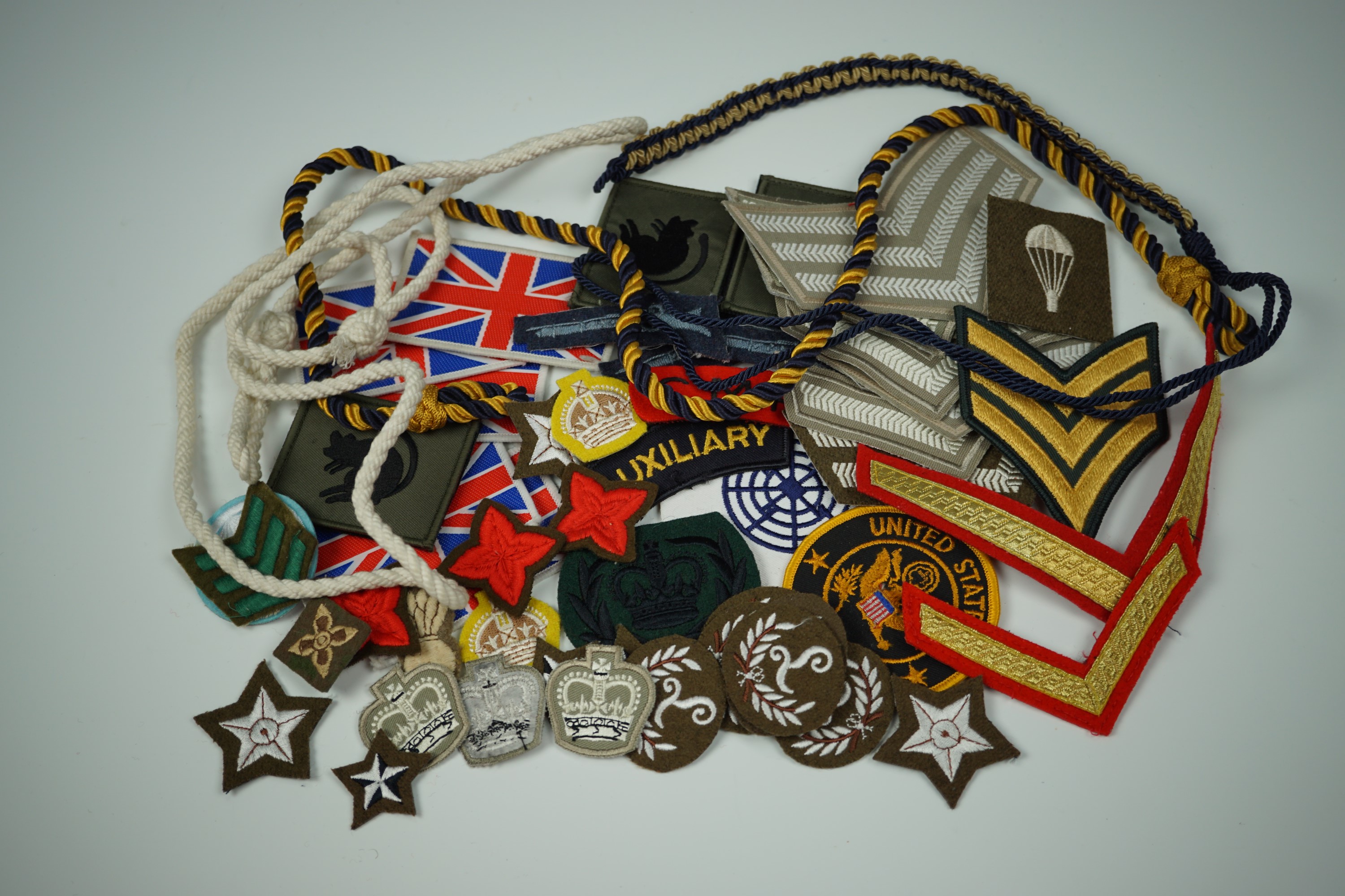 Sundry items of military cloth insignia and lanyards