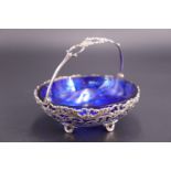 A late 19th / early 20th Century Gorham white metal swing-handled basket with cobalt blue glass