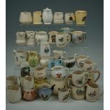 A large collection of tourist souvenir milk / cream jugs