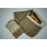 Two khaki cotton pouches containing bandages and other first aid equipment, together with a military