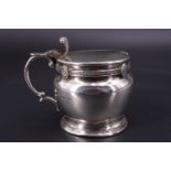 A George V silver mustard pot, of compressed ovoid form decorated with a fine guiloche-moulded