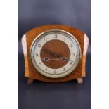 A 1950s Smiths cross-banded walnut mantle clock, having a two-train movement