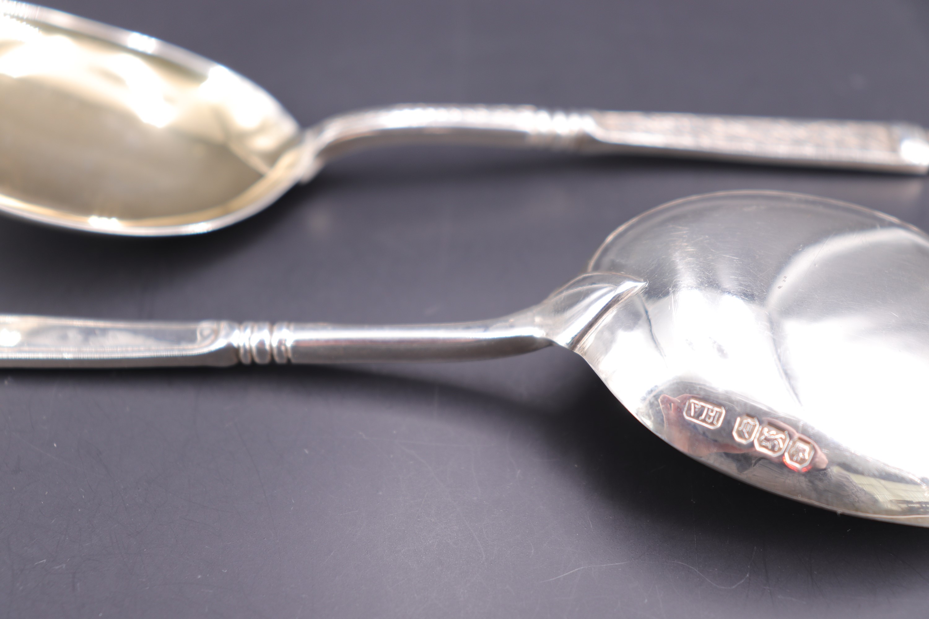 A pair of late Victorian silver serving spoons, each having Romanesque relief-moulded terminal and - Image 2 of 2