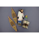 An Inuit doll, miniature show shoes and boots / kamik