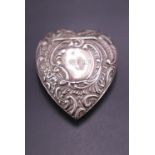 A late Victorian silver heart-shaped patch or similar box, each face relief-decorated in a rococo