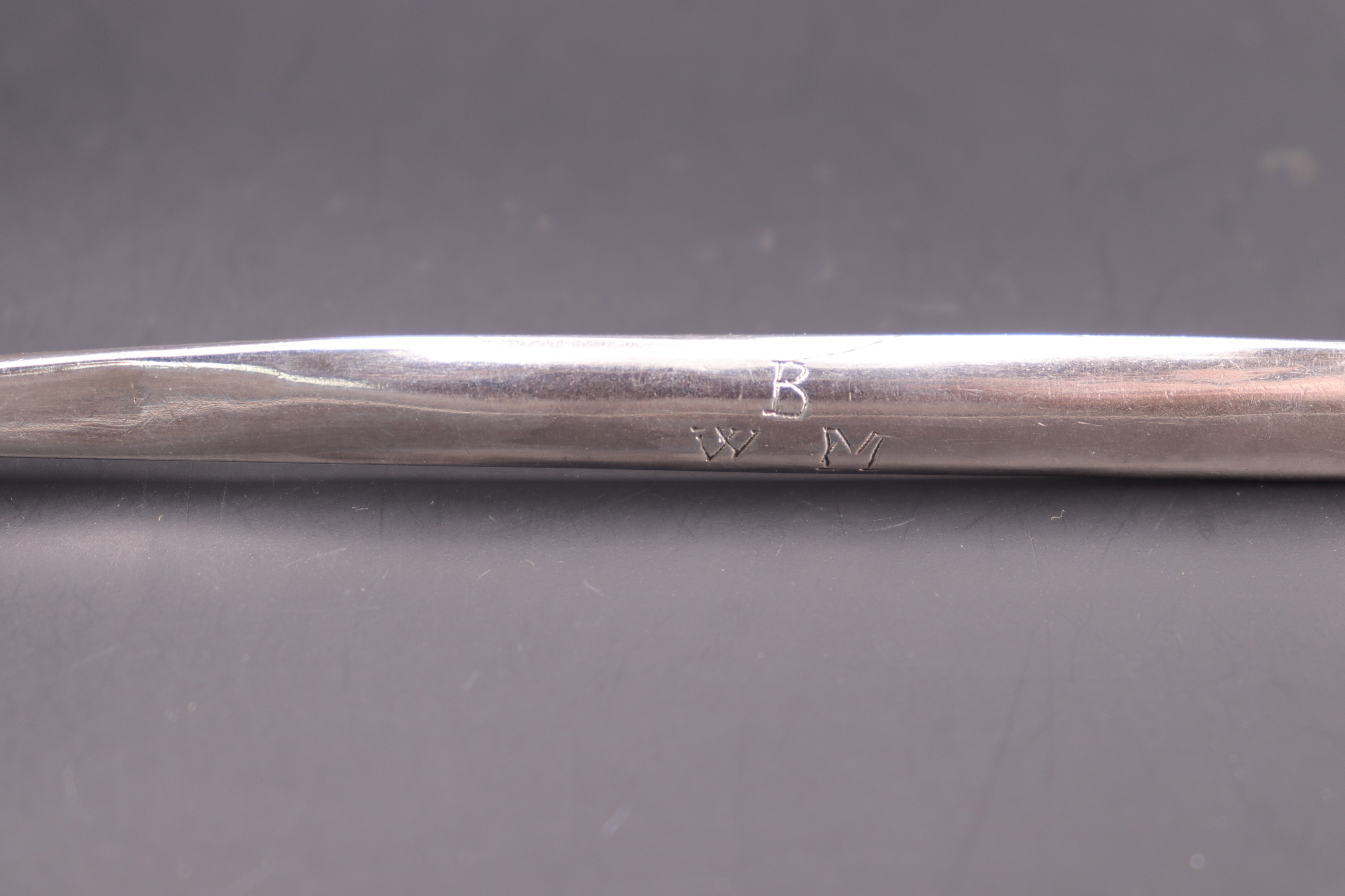 An 18th Century silver scroll-back marrow spoon, bearing engraved marriage marks, WW, London, likely - Image 3 of 3