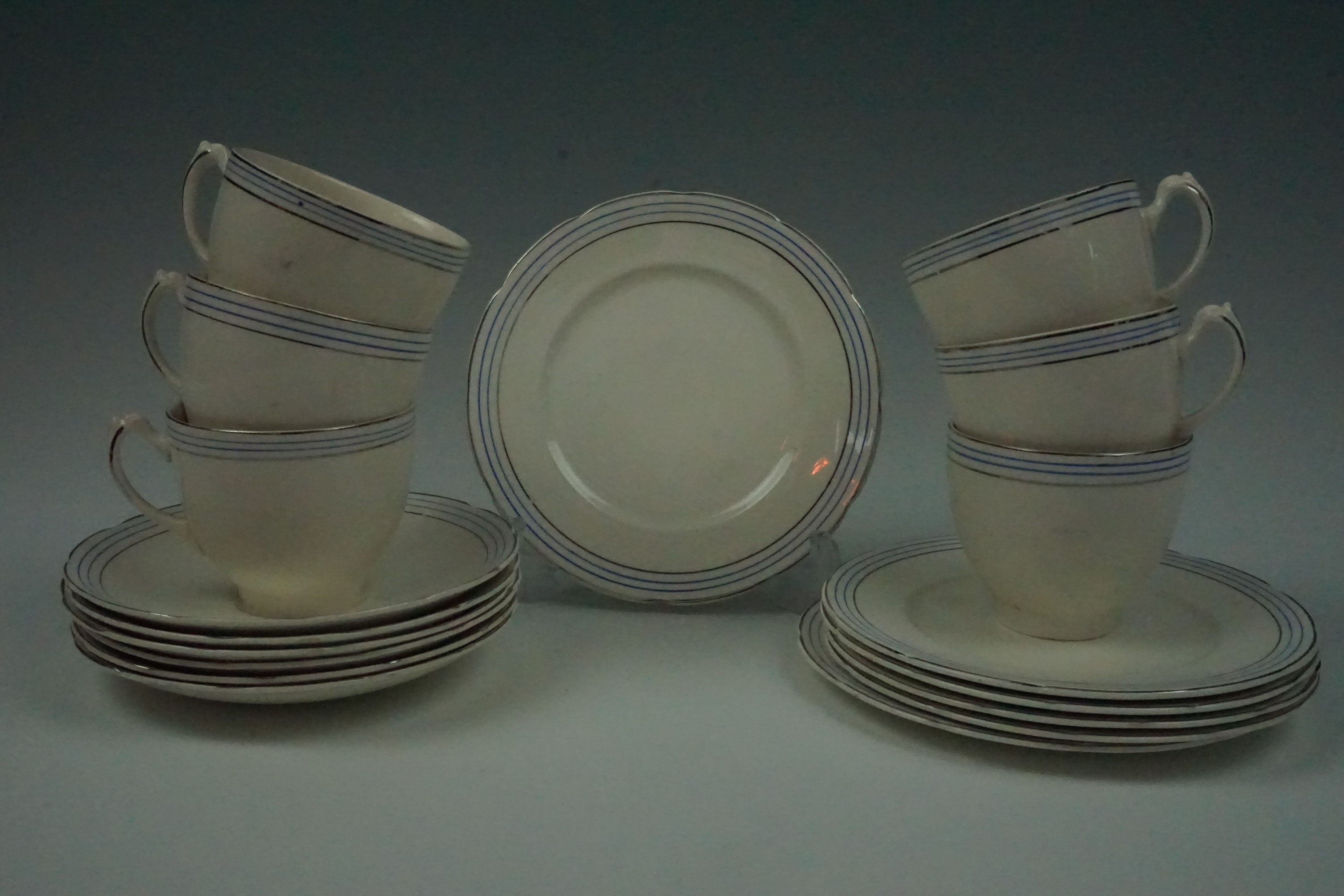 A 1930s tea set for six, in white with blue and silver lined rims