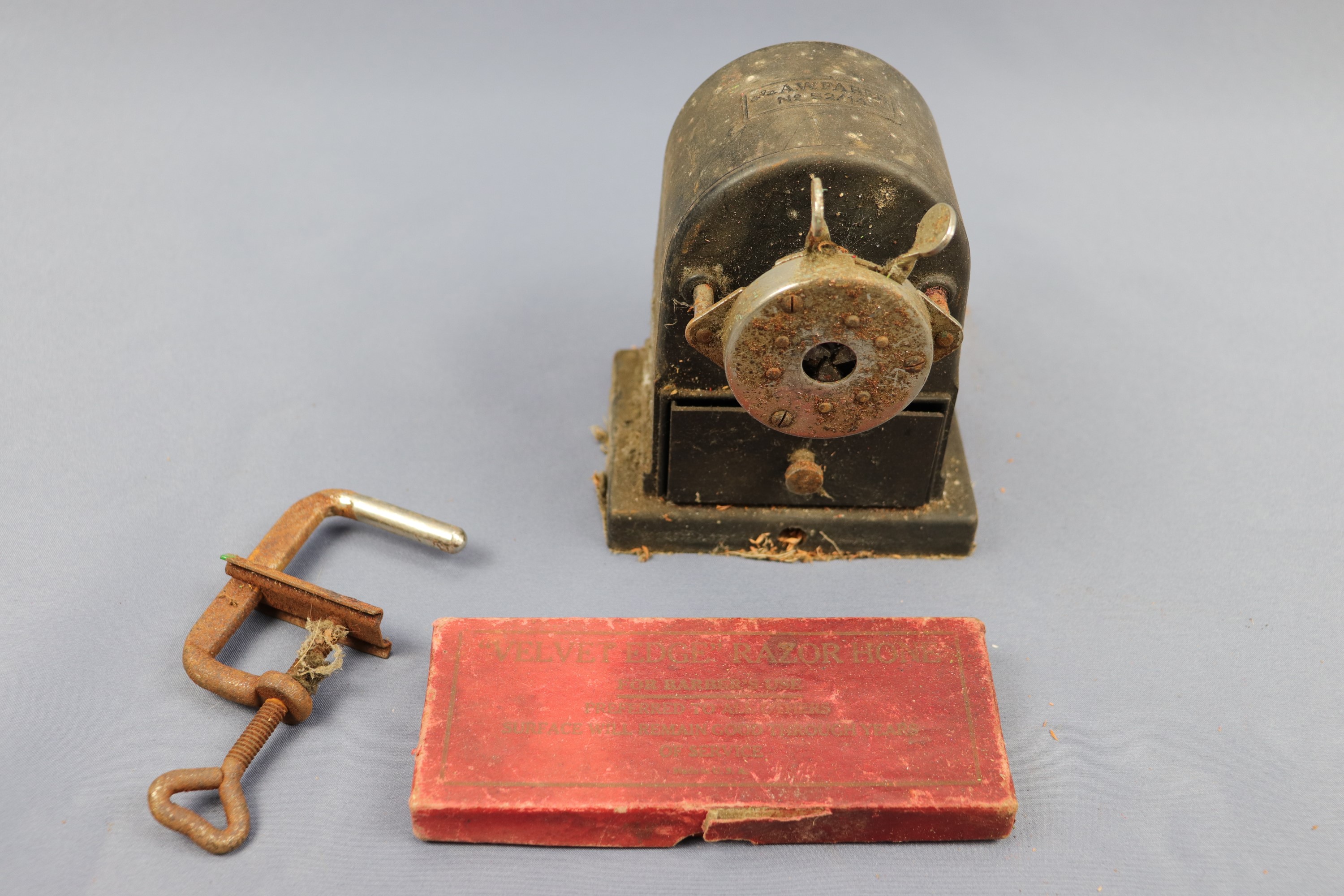 A mid-20th Century Faber desk-mounting pencil sharpener together with an early 20th Century "