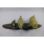 An Inuit carved green serpentine sculpture of three walruses, 29 cm