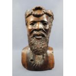 A large African carved hardwood bust of a bearded man with head ornament and necklace, 33 cm