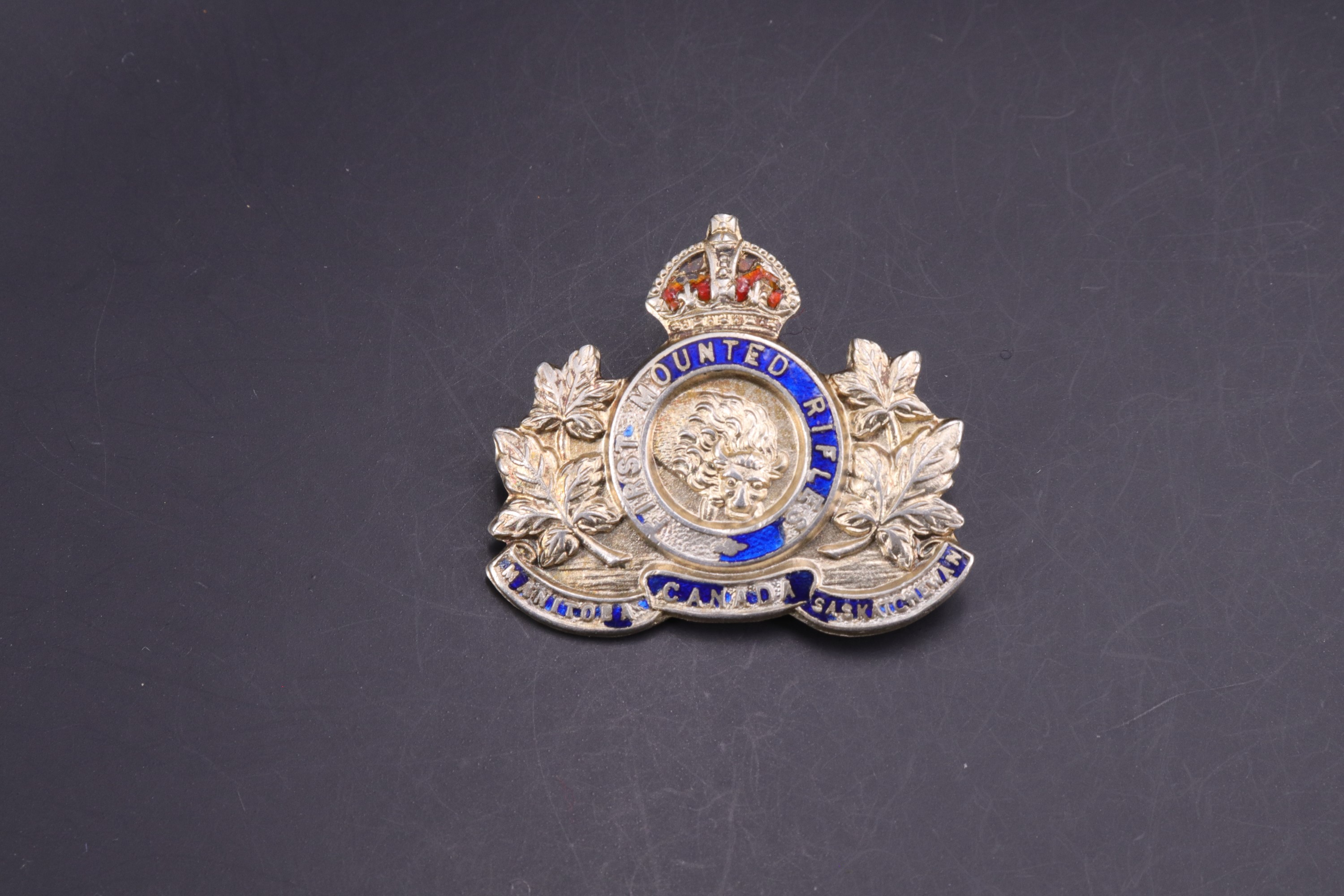 A Canadian First Mounted Rifles enamelled white metal sweetheart brooch, stamped silver