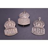 Three silver ARP lapel / cap badges