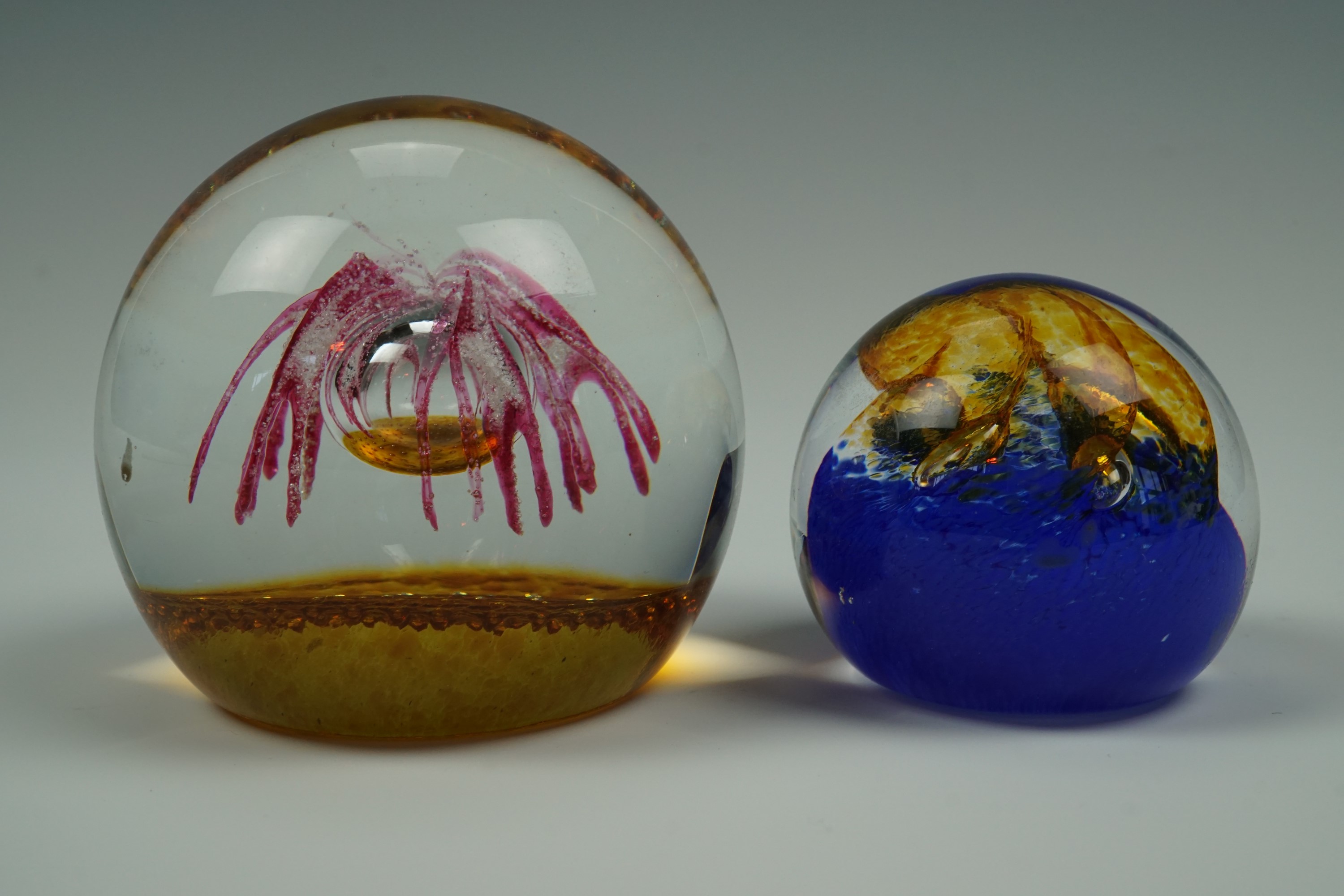 A Caithness "Pebble" glass paperweight together with a small Tweedsmuir Glass weight