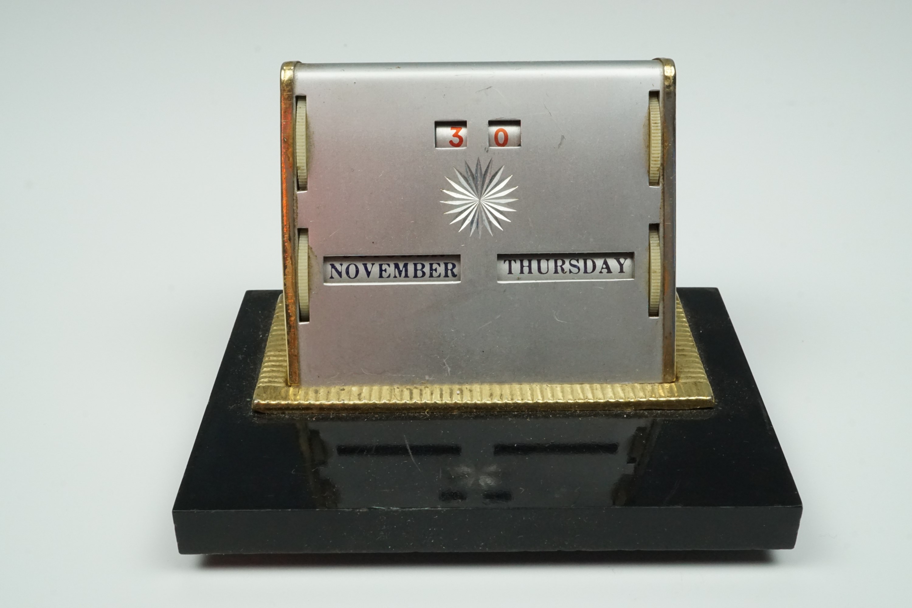 A 1950s perpetual desk calendar, 10.5 cm x 7.5 cm