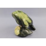 An Inuit carved green serpentine sculpture of a sea cow, signed, 19 cm