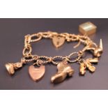 A 9ct gold charm bracelet with five charms and two padlock clasps, 29.9 g